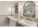 Bright bathroom featuring double sinks, marble countertop, and modern mirrors at 978 Eden Se Ave, Atlanta, GA 30316