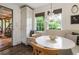Cozy breakfast nook with a built-in bench, white table, and pendant lighting fixture at 978 Eden Se Ave, Atlanta, GA 30316