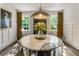 Dining area boasts a round marble table and stylish, sheer seating at 978 Eden Se Ave, Atlanta, GA 30316