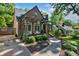 Home featuring brick and stone accents, front yard with manicured landscaping, and a covered porch with seating at 978 Eden Se Ave, Atlanta, GA 30316
