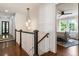 Second floor hallway with chandelier and view into the bedroom at 978 Eden Se Ave, Atlanta, GA 30316