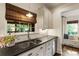 Sunlit kitchen boasts granite countertops, stainless steel sink, and white subway tile backsplash at 978 Eden Se Ave, Atlanta, GA 30316