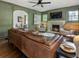 Inviting living room with a fireplace, a brown leather sofa, and view to dining room at 978 Eden Se Ave, Atlanta, GA 30316