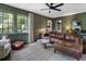 Cozy living room with green walls, large windows, and a comfortable leather sofa at 978 Eden Se Ave, Atlanta, GA 30316