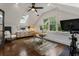 This home office has a skylight, large window, hardwood floors, and exercise equipment at 978 Eden Se Ave, Atlanta, GA 30316