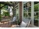 Inviting patio area with brick flooring, comfortable seating, and ample natural light through large windows at 978 Eden Se Ave, Atlanta, GA 30316
