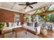 Well decorated screened porch with wooden beams, brick, plants, and comfortable furniture at 978 Eden Se Ave, Atlanta, GA 30316