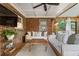 Well decorated brick screened porch featuring comfortable seating and a large TV at 978 Eden Se Ave, Atlanta, GA 30316