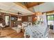 Comfortable screened porch with exposed brick, wooden beams, and plenty of seating at 978 Eden Se Ave, Atlanta, GA 30316