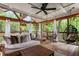 Screened porch with a seating area, dining area, string lights, and a hanging chair at 978 Eden Se Ave, Atlanta, GA 30316