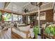 Relaxing screened porch with a ceiling fan, comfortable seating, and brick wall with mounted television at 978 Eden Se Ave, Atlanta, GA 30316