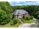 Beautiful aerial view of a two-story brick home with lush landscaping and a circular driveway at 11569 Finley St, Suwanee, GA 30024