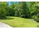 Expansive backyard features mature trees and offers plenty of room to enjoy the outdoors at 11569 Finley St, Suwanee, GA 30024