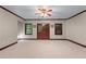 Expansive carpeted basement with natural light from a set of exterior doors and windows at 11569 Finley St, Suwanee, GA 30024