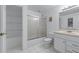 Bright bathroom with shower-tub combo, storage, and a single sink vanity at 11569 Finley St, Suwanee, GA 30024