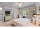Serene bedroom with soft lighting, neutral tones, and a comfortable bed with plush pillows at 11569 Finley St, Suwanee, GA 30024