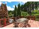 Outdoor deck with dining set, perfect for al fresco meals and entertaining guests with a view at 11569 Finley St, Suwanee, GA 30024
