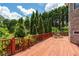 Wooden deck features a seating area and overlooks mature landscaping and greenery at 11569 Finley St, Suwanee, GA 30024