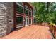 Expansive wooden deck with chairs overlooks a lush backyard, perfect for outdoor entertaining at 11569 Finley St, Suwanee, GA 30024