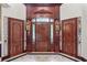 Elegant entrance with ornate wood doors and decorative details, showcasing craftsmanship and style at 11569 Finley St, Suwanee, GA 30024