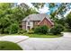 Stunning brick home with stone accents, a circular driveway, and lush landscaping at 11569 Finley St, Suwanee, GA 30024