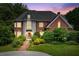 Charming brick home with stone accents, lush landscaping, and a welcoming entryway at 11569 Finley St, Suwanee, GA 30024
