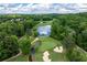 Aerial view showcasing a lush green golf course with mature trees and scenic water features at 11569 Finley St, Suwanee, GA 30024