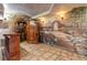 Hallway with arched doorway, intricate mural, stone flooring, and custom woodwork at 11569 Finley St, Suwanee, GA 30024