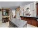 Eat-in kitchen with granite counters, center island, stainless appliances, and desk area at 11569 Finley St, Suwanee, GA 30024