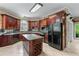 Spacious kitchen features custom wood cabinets, stainless appliances and island with wine rack at 11569 Finley St, Suwanee, GA 30024