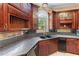 Granite countertops, custom wood cabinets and stainless steel sink featured in this kitchen at 11569 Finley St, Suwanee, GA 30024
