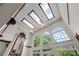 Bright living room with ceiling fans, skylights and large windows overlooking the trees at 11569 Finley St, Suwanee, GA 30024