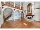 Grand living room with fireplace, hardwood floors, staircase and mural at 11569 Finley St, Suwanee, GA 30024