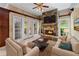 Cozy living room featuring stone fireplace, French doors and comfortable seating area at 11569 Finley St, Suwanee, GA 30024