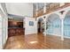 Open-concept living room with access to kitchen, staircase and mural at 11569 Finley St, Suwanee, GA 30024