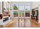 Spacious living room with fireplace, hardwood floors, large windows and access to the deck at 11569 Finley St, Suwanee, GA 30024