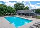 Community pool with lounge chairs and tables surrounded by manicured landscaping at 11569 Finley St, Suwanee, GA 30024