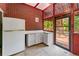 Sunroom features brick walls, tile floor, and a door to the exterior deck at 11569 Finley St, Suwanee, GA 30024