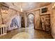 Wine cellar with custom wrought iron accents, textured walls, and tiled floor at 11569 Finley St, Suwanee, GA 30024