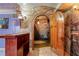 Wine cellar entrance featuring custom woodwork, stone flooring, and mural at 11569 Finley St, Suwanee, GA 30024