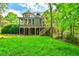Lush backyard featuring a screened-in porch and large mature trees, creating a serene outdoor space at 2111 Broadfield Run, Duluth, GA 30097