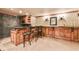 Basement bar area featuring custom wood accents, granite countertops, seating, and recessed lighting for entertaining at 2111 Broadfield Run, Duluth, GA 30097