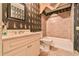 View of a bathroom featuring a vanity, toilet, combination shower and tub, and decorated with dark green wallpaper at 2111 Broadfield Run, Duluth, GA 30097