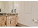 Powder room featuring elegant wainscoting and a granite countertop at 2111 Broadfield Run, Duluth, GA 30097