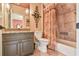 Traditional-style bathroom featuring decorative sconces, a shower-tub combo, and granite countertops at 2111 Broadfield Run, Duluth, GA 30097