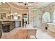 Spacious primary bathroom with double vanity, glass shower, soaking tub, decorative windows, and a seating area at 2111 Broadfield Run, Duluth, GA 30097