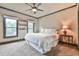Cozy bedroom with soft carpet, a ceiling fan, two windows, and a queen-size bed at 2111 Broadfield Run, Duluth, GA 30097