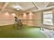 Versatile bonus room featuring an exercise area, putting green, and carpet for a variety of recreational activities at 2111 Broadfield Run, Duluth, GA 30097