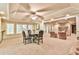 Open bonus room with a table and chairs, fireplace, and windows for a cozy and inviting atmosphere at 2111 Broadfield Run, Duluth, GA 30097