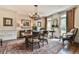Formal dining room with hardwood floors, wainscoting, and elegant lighting at 2111 Broadfield Run, Duluth, GA 30097